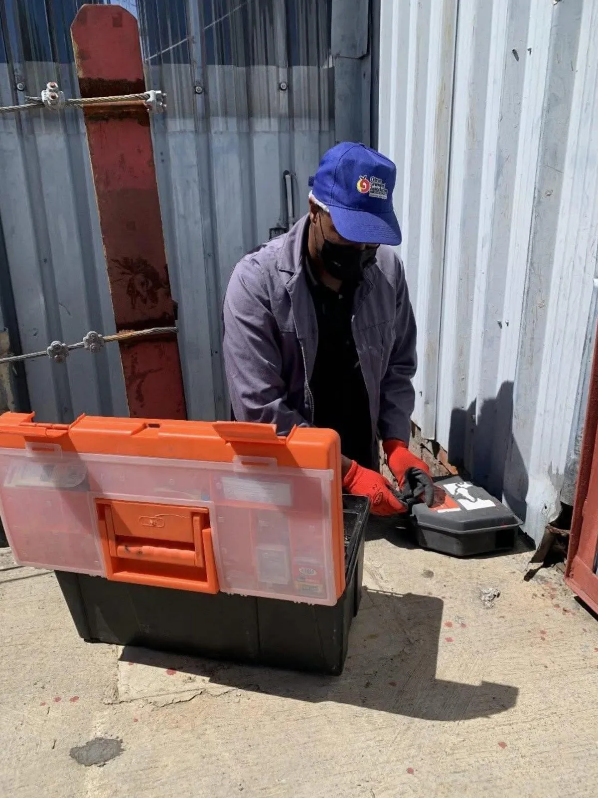 Registered ASC technician servicing a rodent bait station during a residential visit